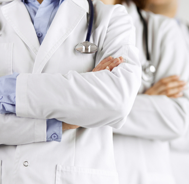 Group,Of,Modern,Doctors,Standing,As,A,Team,With,Arms